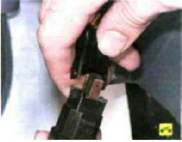 4. Отожмите фиксаторы и отсоедините от выключателя колодку жгута проводов.